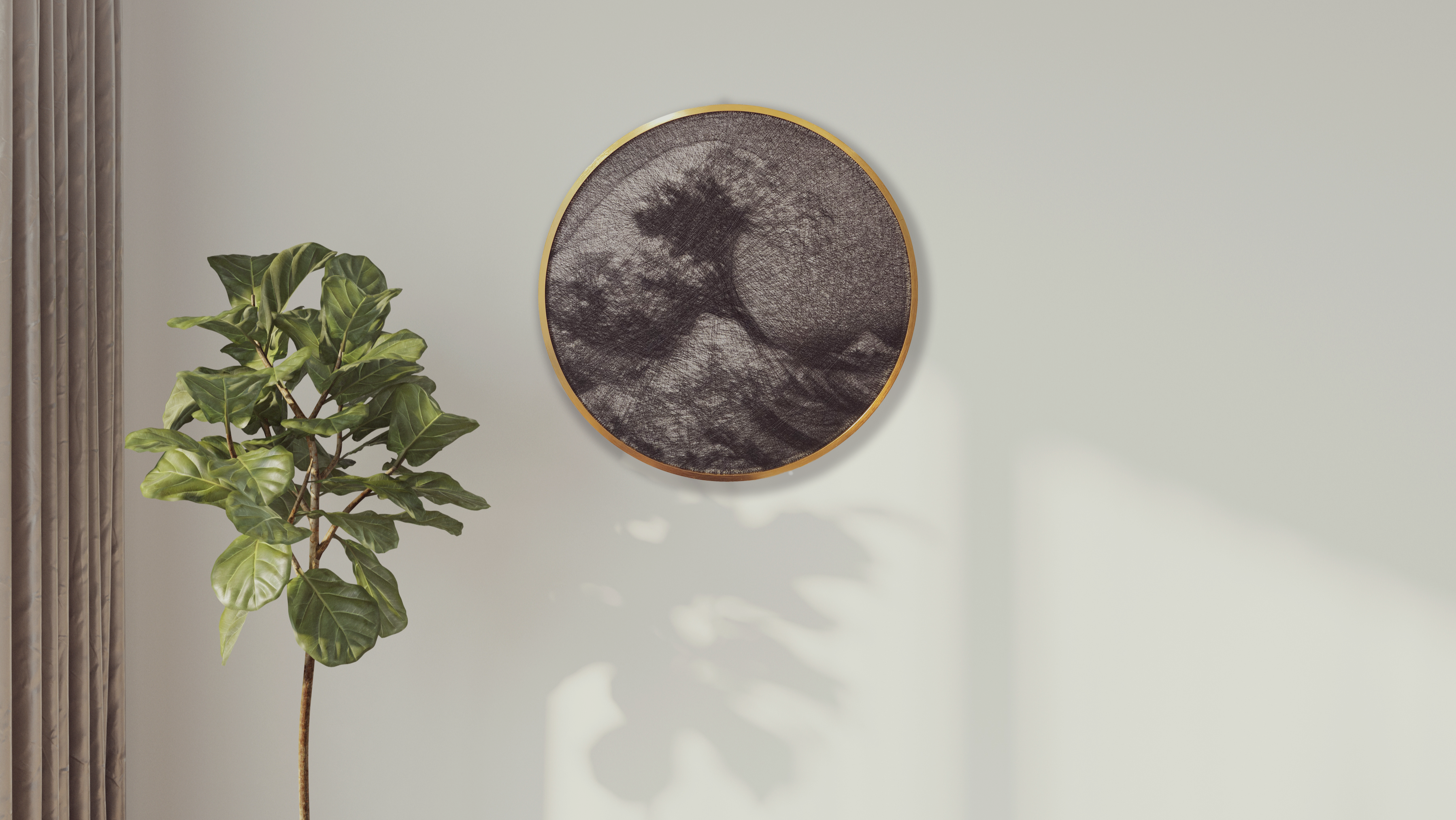 Round wall art piece with a natural frame on a light gray wall next to a plant.