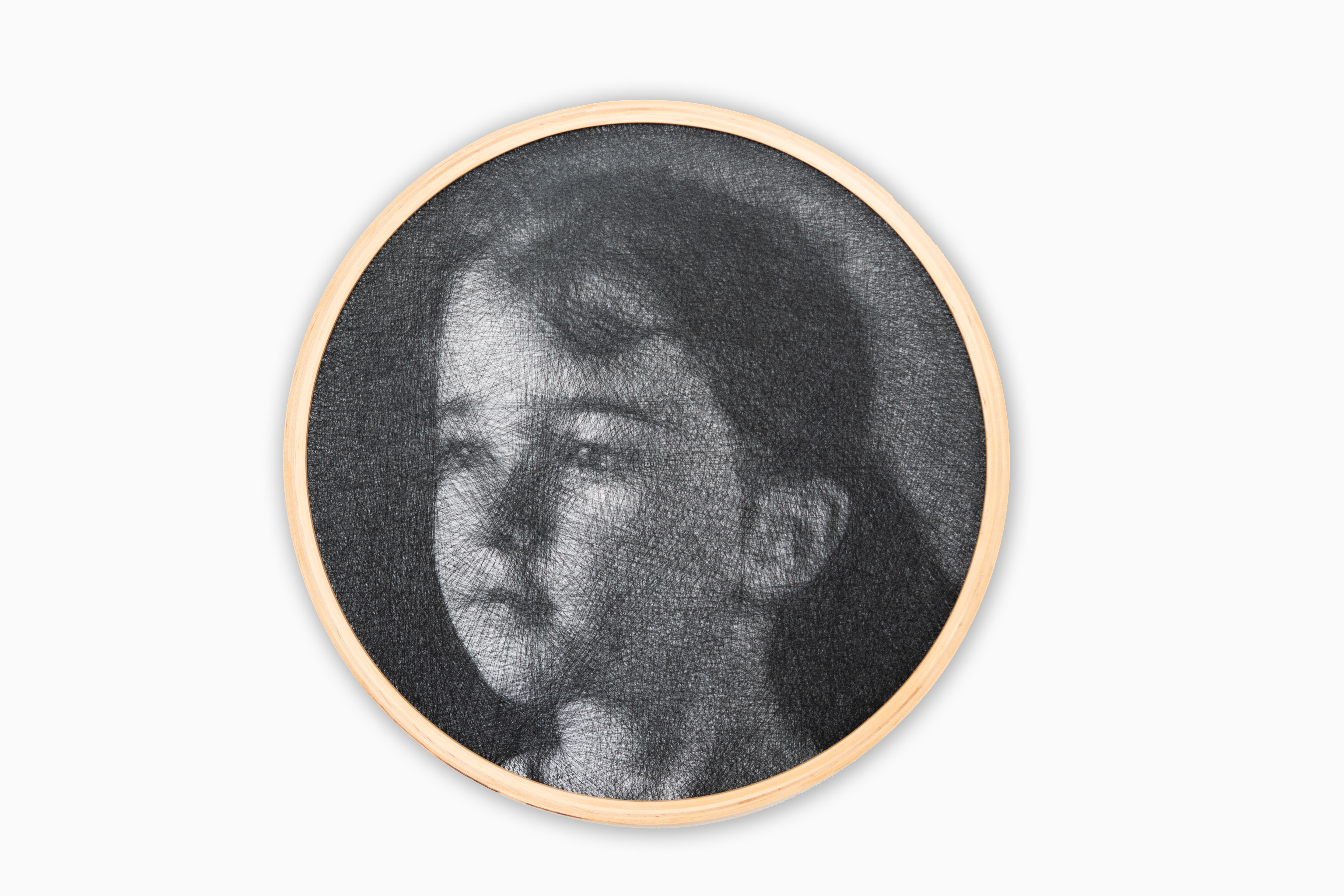 Circular framed black and white portrait on a white background