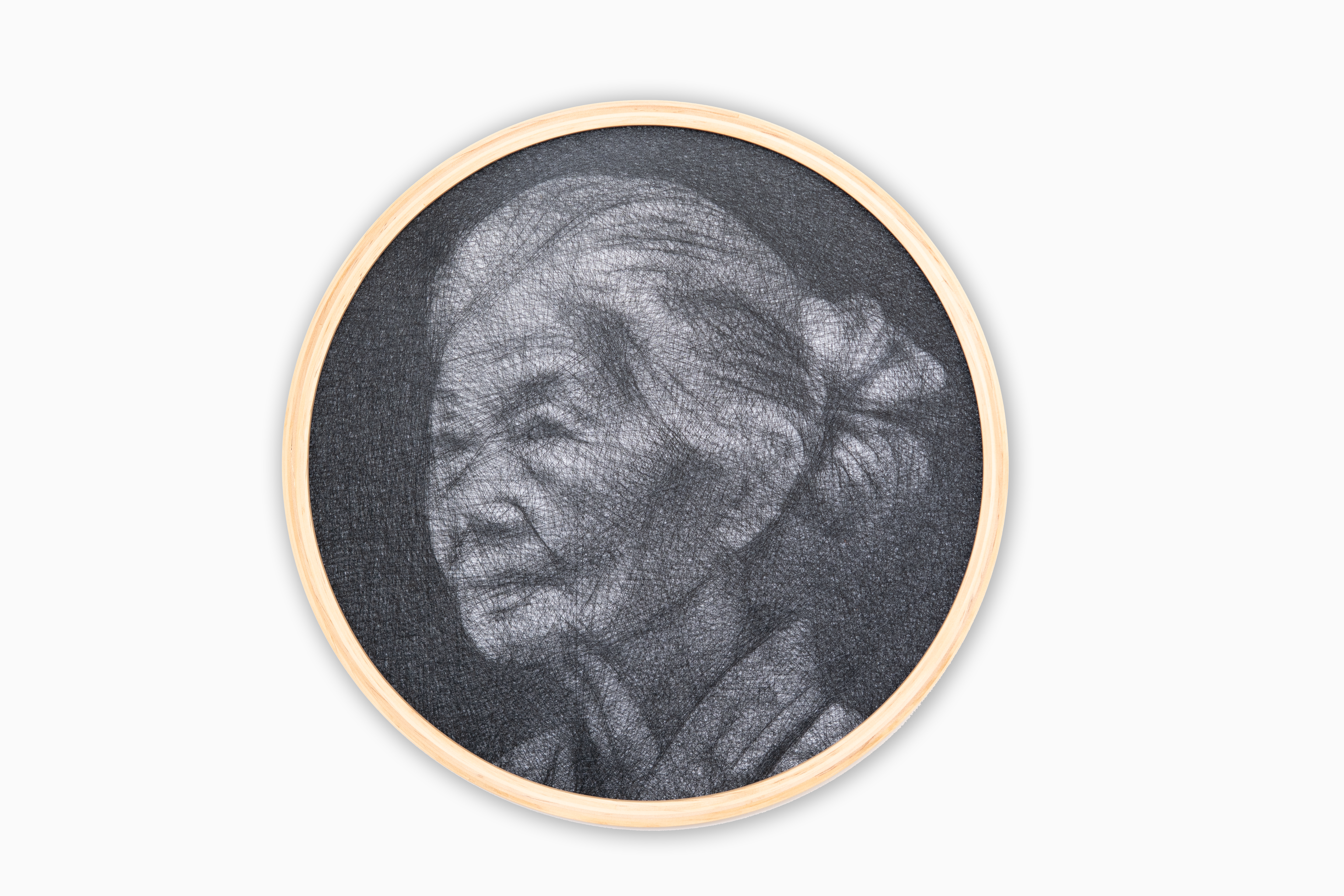 Circular framed artwork of an elderly woman's portrait on a white background